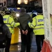 A man is taken away by South Yorkshire Police, after they arrested him at the top of Fargate during Operation Calibre this week. The Star was invited to shadow their patrol. Picture: David Kessen, National World