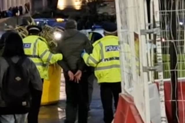 Police take a man away after an arrest in Sheffield city centre during Operation Calibre. Picture: David Kessen, National World