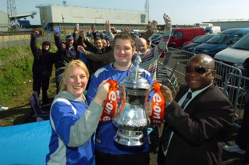 Pompey fans Emma and Bret Hopping get their hands on the FA Cup thanks to the FA's Hassan Enahoro, as they queue for Cup tickets in 2008