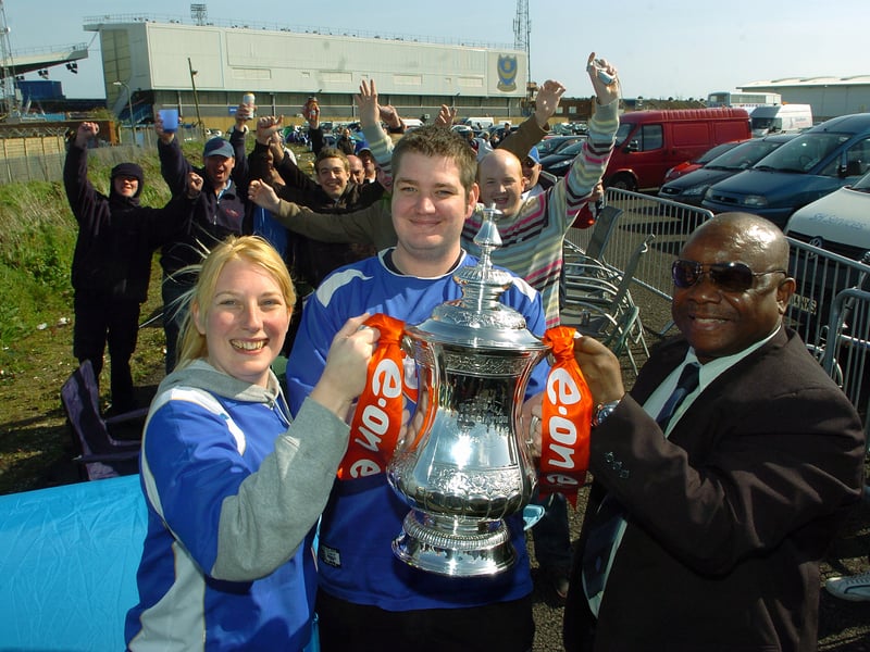 Pompey fans Emma and Bret Hopping get their hands on the FA Cup thanks to the FA's Hassan Enahoro, as they queue for Cup tickets in 2008