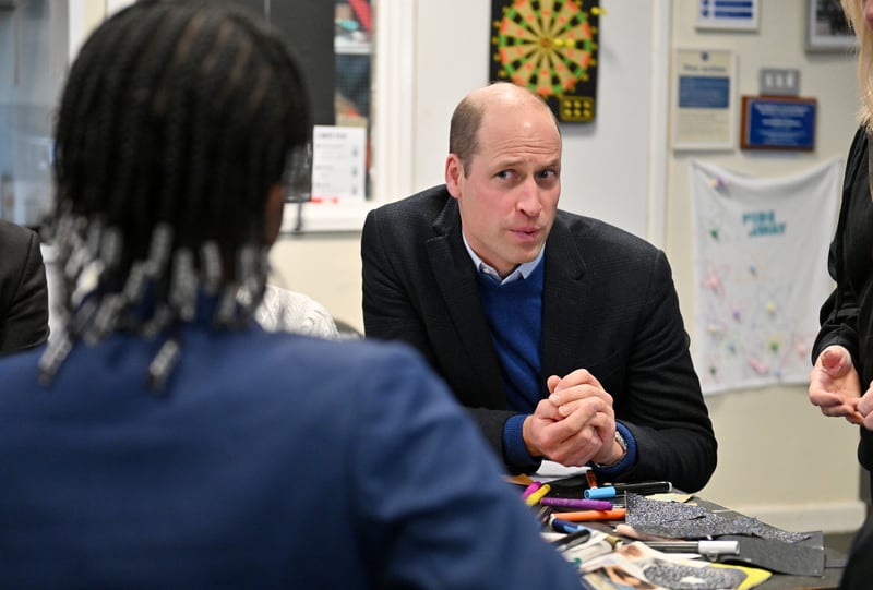 Prince William listens to youngsters at the Hideaway Youth Project 