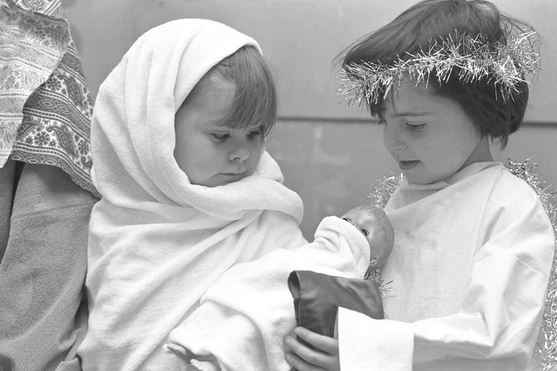 Four year olds Kerry Ann Hewitson (left) and Jack Sanderson make sure the doll is well wrapped up at the Blackfell Infants' School Nativity in 1974.