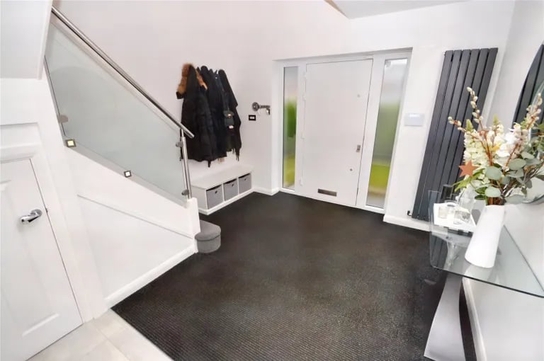 Enter into this large hallway with stairs to the first floor and access to all the ground floor rooms.