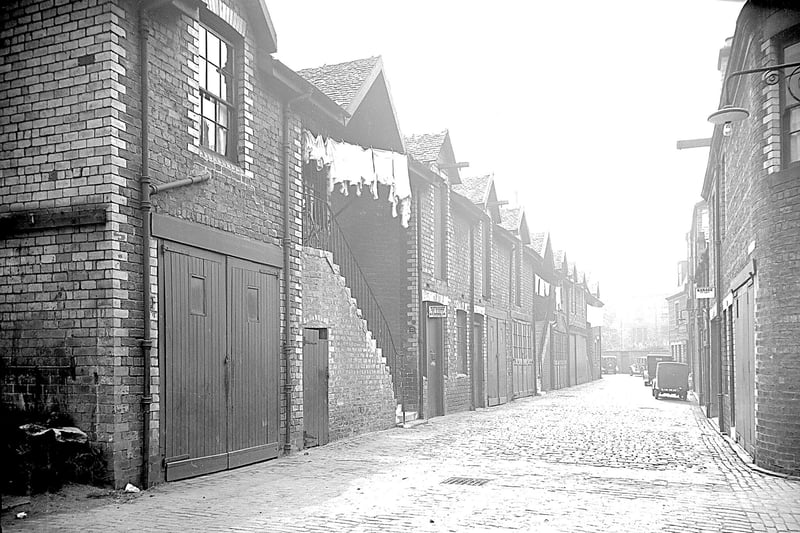 A view down Ashton Lane in 1933 which has been completely transformed over 90 years later.