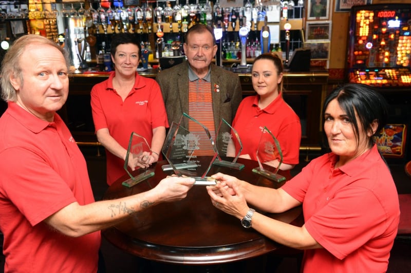 Landlord Kelvin Lamb, bar staff Kelly Kennedy, customer Peter Foster, bar staff Samantha Steven and manageress Lisa Smith with the trophy for Pub of the Year.