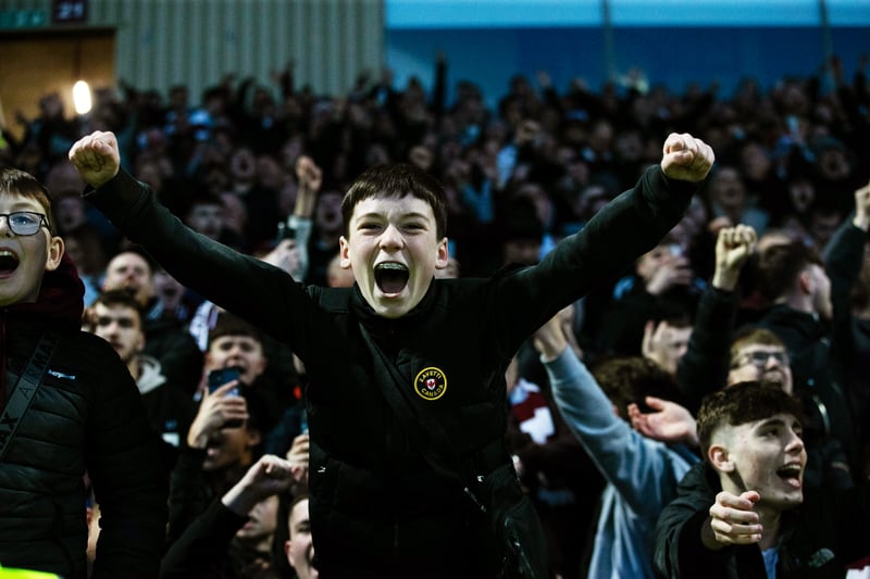 A young Jambos fan celebrates Lawrence Shankland's goal at Motherwell.