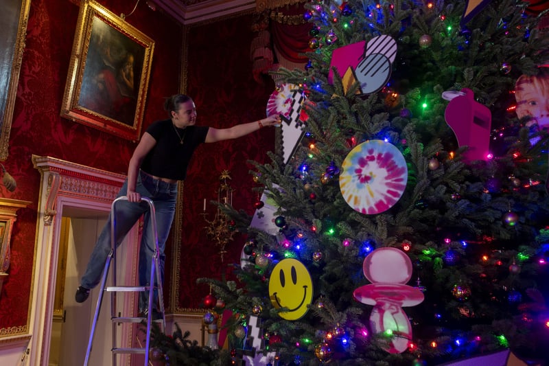 Pictured is Emma Loughnane putting the finishing touches to  the 1980's silent disco Christmas tree.