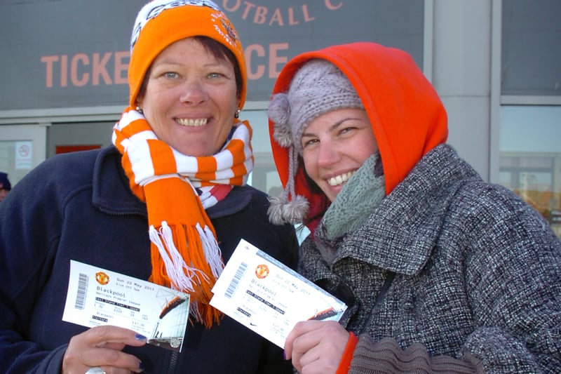 Debbie and Victoria Harrison clutch their precious tickets for Blackpool's Premier League game against Manchester United after a long stand in the queue