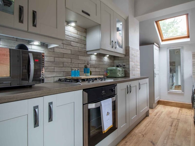 The kitchen boasts "sleek finishes and ample storage space". (Photo courtesy of Zoopla)