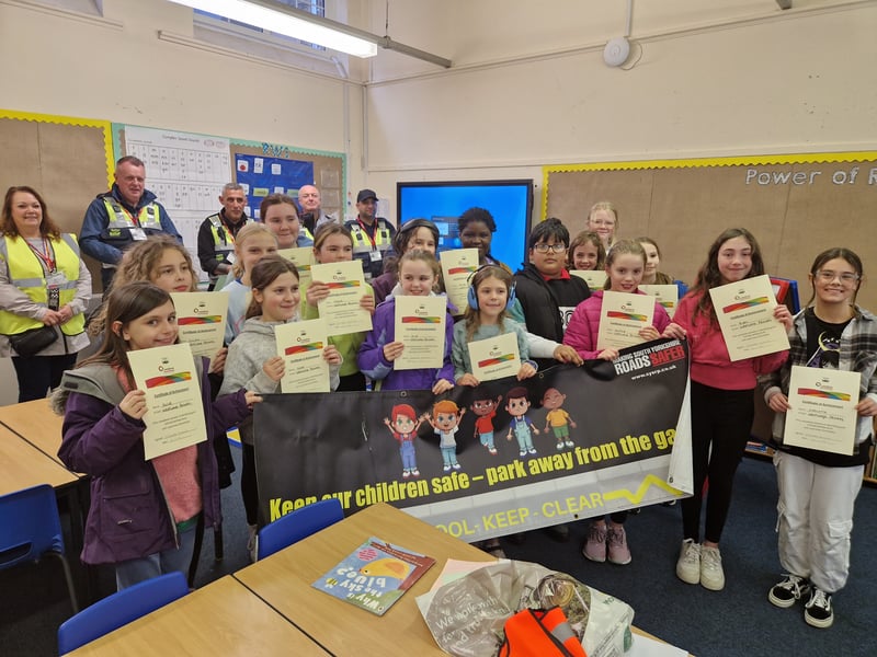 Youngsters at Westways Primary school with a banner that is being put outside the school as part of the Good/Bad Parking scheme. Picture: David Kessen, National World