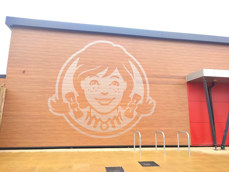 A smiling Wendy whose face is emblazoned across the wall, provides a warm welcome to Derby diners