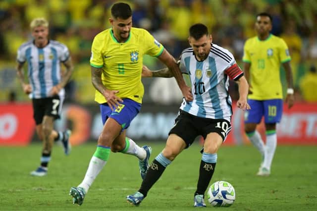 Argentina's forward Lionel Messi (R) and Brazil's midfielder Bruno Guimaraes fight for the ball during the 2026 FIFA World Cup South American qualification football match between Brazil and Argentina. (Photo by CARL DE SOUZA / AFP) (Photo by CARL DE SOUZA/AFP via Getty Images)