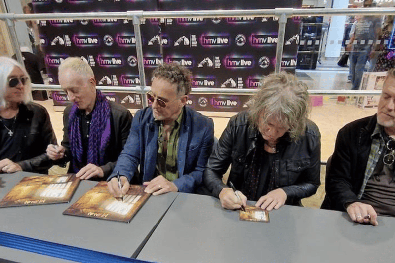 Def Leppard hard at work signing albums for fans at HMV Meadowhall in May, weeks after it opened.