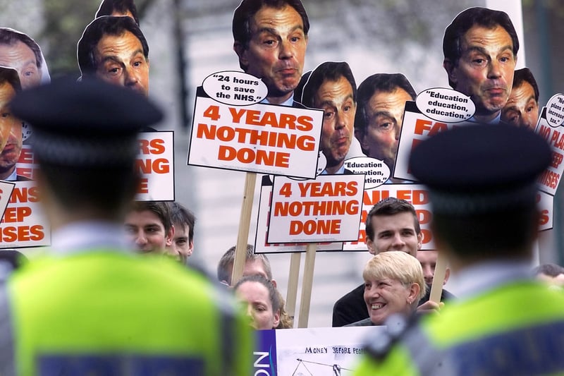 Police keep a watch on demonstrators outside The International Convention Centre in Birmingham before the departure of British Prime Minister Tony Blair 16 May 2001, after his delivery of the New Labour manifesto. Electioneering continues until poling day on the 07 June 2001. 