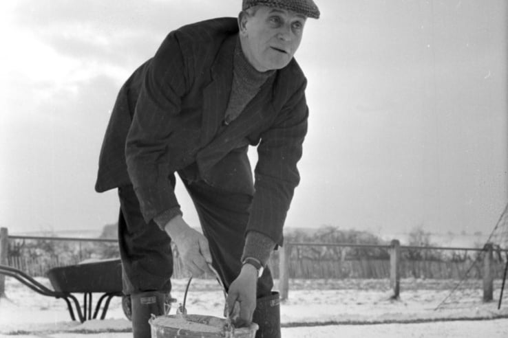 The groundsman at Ryhope CW ground busy cleaning the lines of snow in readiness for the December 1965 FA Cup clash against Workington. 