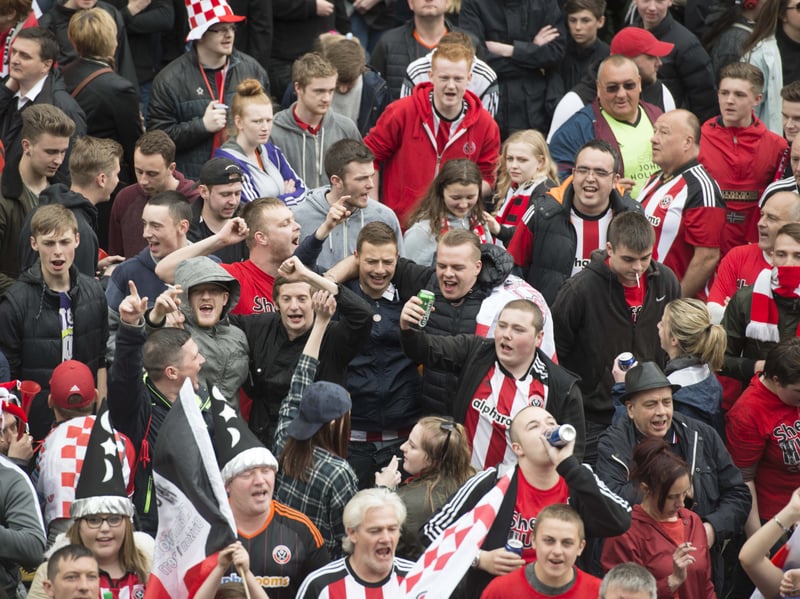 Sheffield United fans celebrate the club's promotion to the Premier League during the club's city centre parade