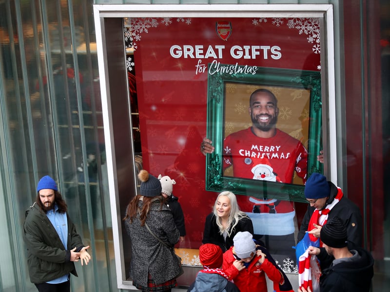 Arsenal fans in Christmas jumpers celebrate a 2-1 victory over Manchester City. Theo Walcott and Oliver Giroud were the scorers on the day. (Getty Images)