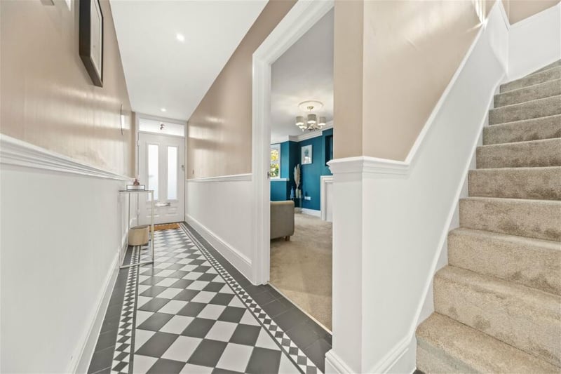 The front door opens to this hand-tiled entrance hall with stairs to the first floor.