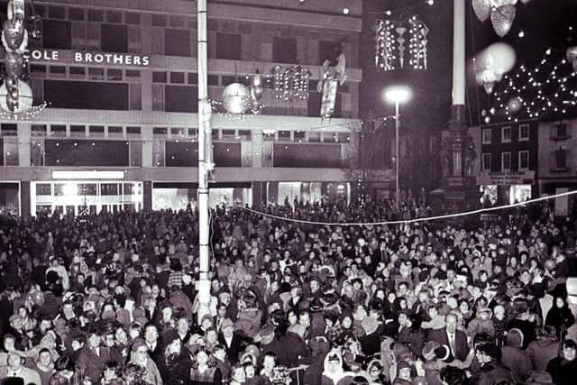 Crowds gather outside Cole Brothers department store at Barker's Pool in Sheffield city centre to see the Christmas lights being switched on in the 1960s