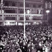 Crowds gather outside Cole Brothers department store at Barker's Pool in Sheffield city centre to see the Christmas lights being switched on in the 1960s