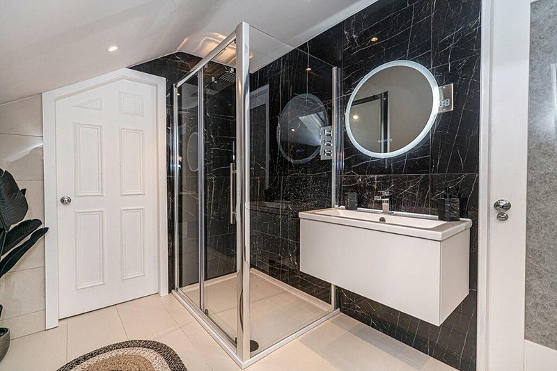 The main bathroom was also designed by Bagno design and is a four piece white suite that includes a separate shower cubicle. 