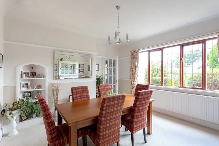 On the other side of the hall is a spacious bright dining room.