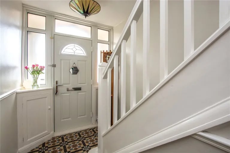 Enter into this hallway with feature tiled floor.