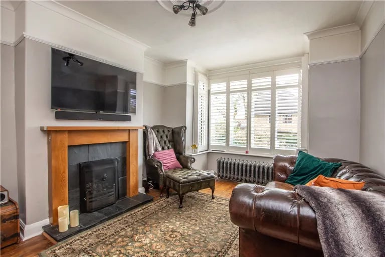 The living room has a bay window to the front elevation and feature fireplace with gas fire.
