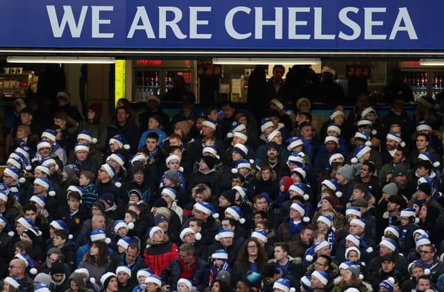 Fans of Chelsea wearing blue santa hats during the Premier League match between Chelsea and Southampton.