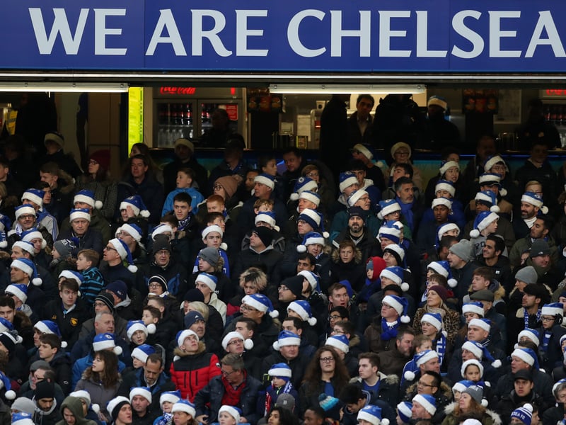 Fans of Chelsea wearing blue santa hats during the Premier League match between Chelsea and Southampton.