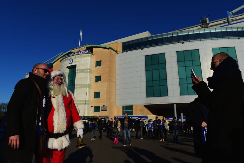 Fans pose with 'Father Christmas' prior to the Barclays Premier League match between Chelsea and Hull City