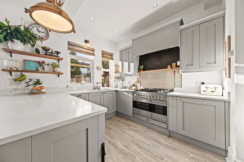 The modern kitchen with a range of base and wall units as well as integrated appliances.