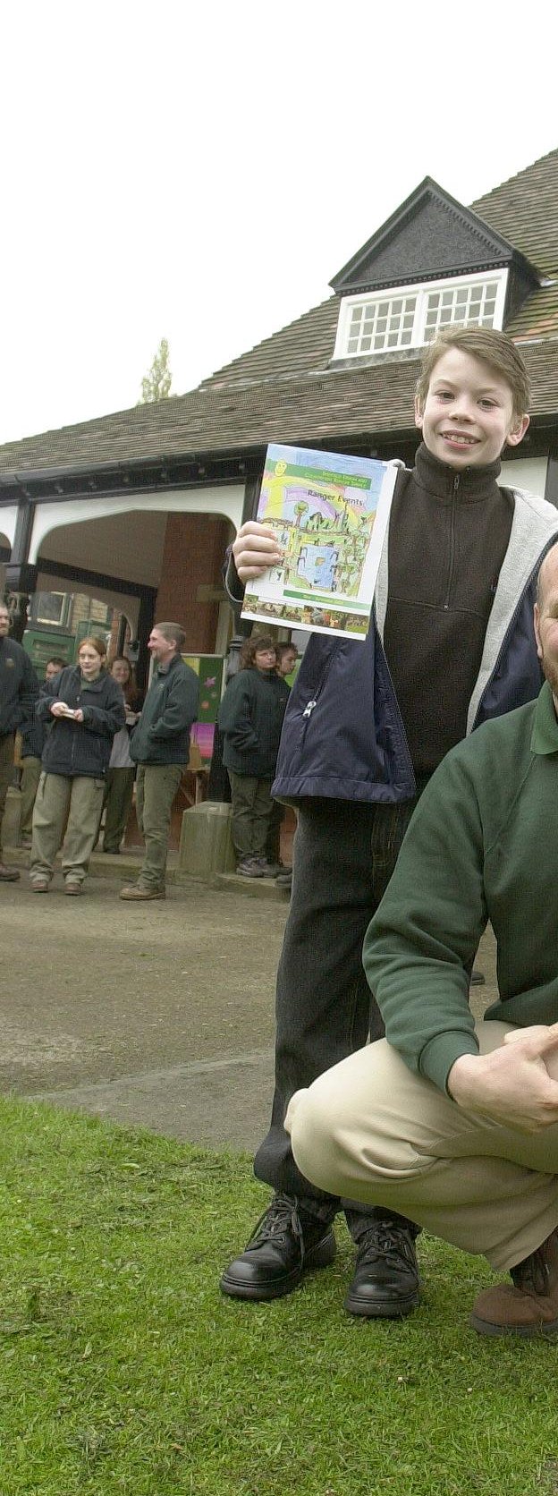 Youngster Mark Stewart, who designed the colour leaflet on Park Ranger events, is congratulated by Ted Talbot, urban and countryside ranger services manager, at the official opening of the Rangers Lodge in Endcliffe Park in 2000