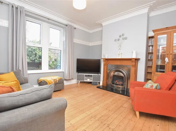 The spacious living room with cast iron living fireplace is ideal for family evenings.