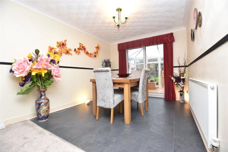 To the rear of the living room is a spacious dining area with access to the conservatory.