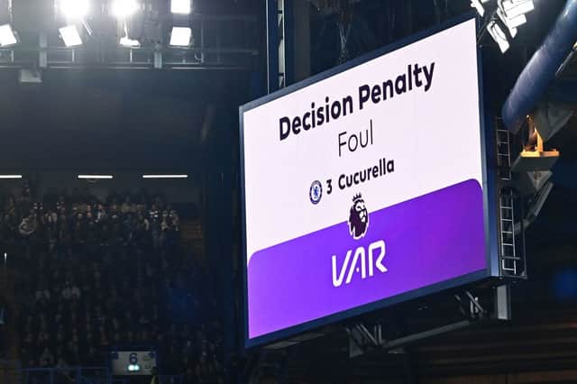 The big screen displays the outcome of a VAR (Video Assistant Referee) review into a foul by Chelsea's Spanish defender #03 Marc Cucurella on Manchester 