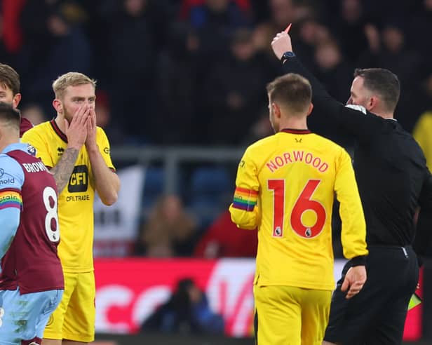 Oli McBurnie of Sheffield United reacts after he is shown a red card by Referee Chris Kavanagh following a second yellow card during the Premier League match between Burnley FC and Sheffield United at Turf Moor  (Photo by Nathan Stirk/Getty Images)