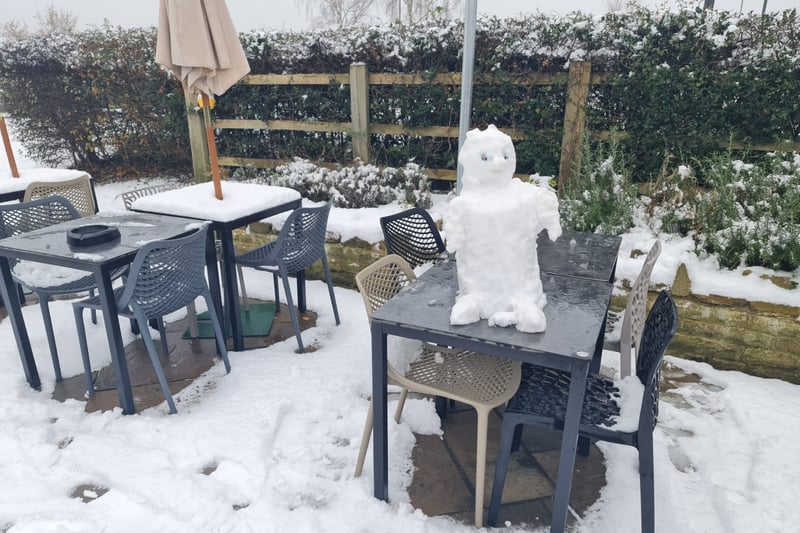 A snowman sits atop a table in the snowy beer garden at the Scarsdale 100 in Beighton, Sheffield