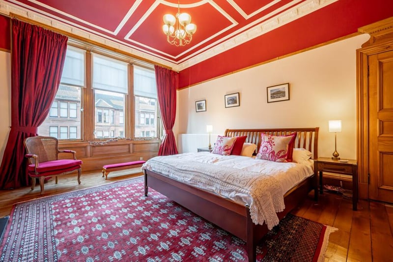 The main bedroom features eye-catching mouldings, ceiling plasterworks and a working fireplace. 