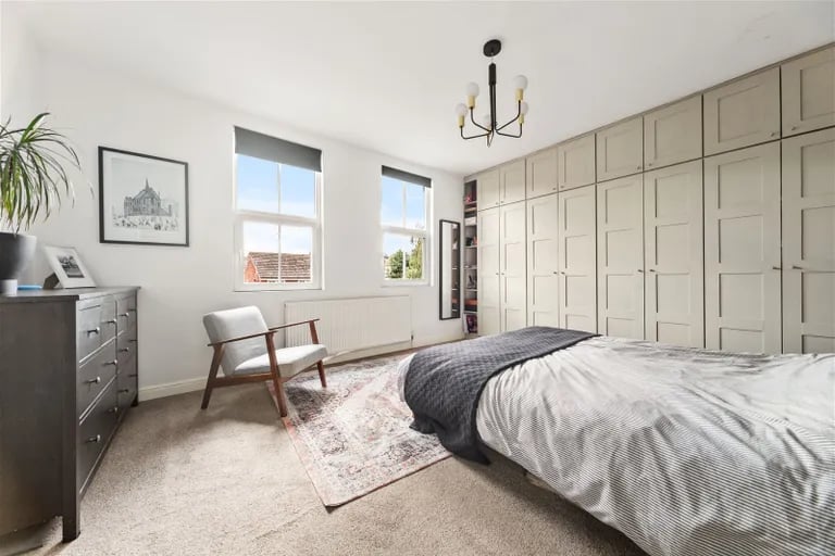To the first floor is this double bedroom with built-in wardrobes.