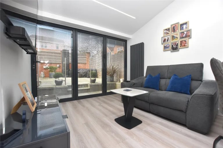 A lounge area with bi-folding doors leads out to the rear garden.
