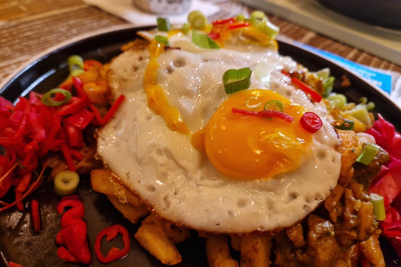 The curry goat hash at Turtle Bay Glasgow - featuring curry goat and mashed spiced fries topped with crispy fried eggs and pickled veg.