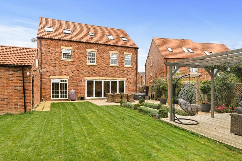 The enclosed rear garden has lawns, patio and decked areas.