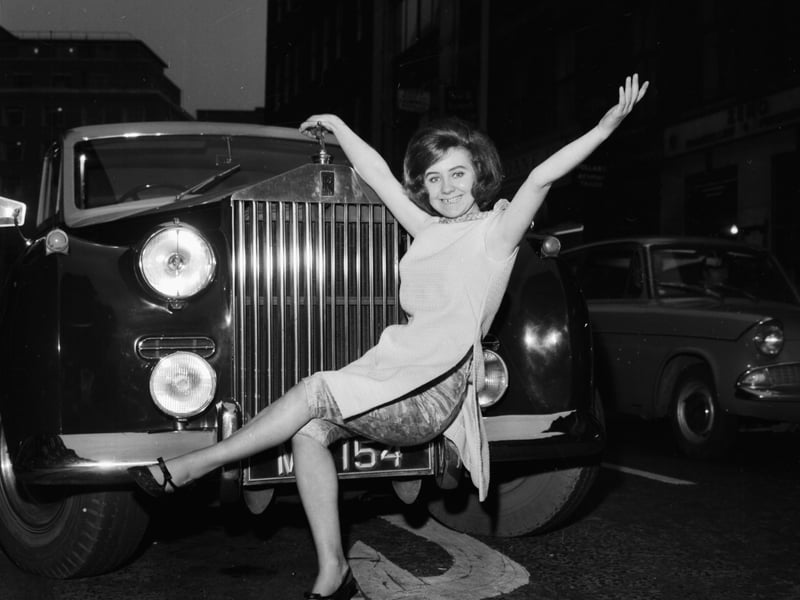 Pop singer Marie Lawrie, of the group 'Lulu and the Lovers', posing on the hood of a car on April 2 1964. 