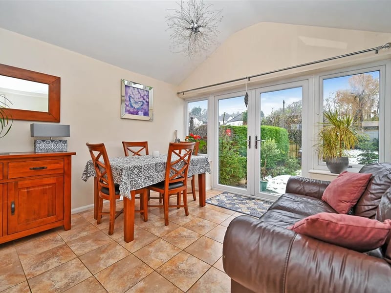 A separate dining room connects to the rear garden via glass doors.
