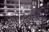 A huge crowd gathers to watch the Christmas lights being switched on at Barker's Pool, Sheffield, in 1974