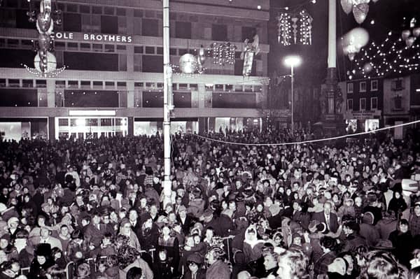 A huge crowd gathers to watch the Christmas lights being switched on at Barker's Pool, Sheffield, in 1974
