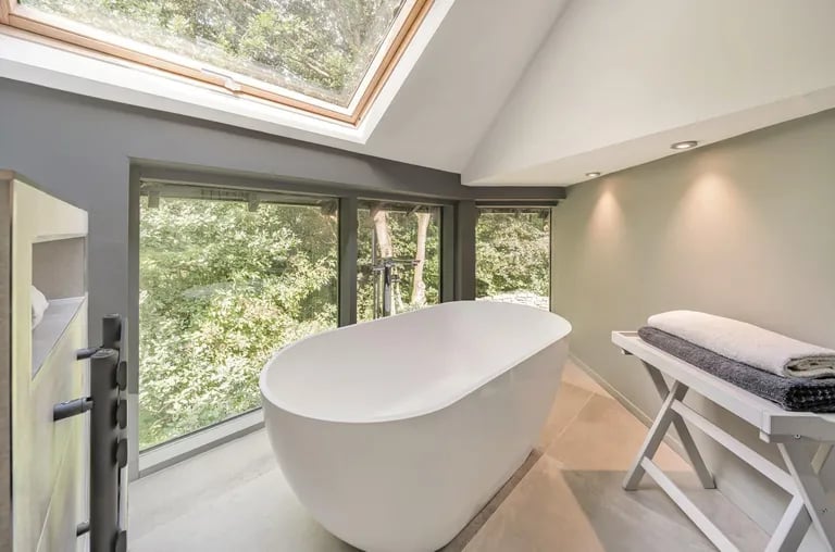 In the luxurious bathroom is a detached bathtub and skylight windows offering a relaxing experience like nowhere else.