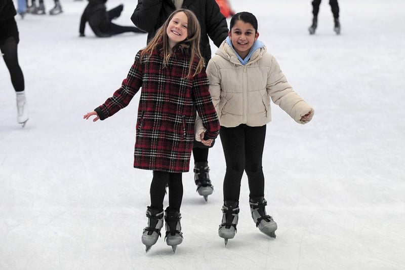 Emmy Shackleton, nine and Alayna Hussain, nine of Heckmondwike pose on ice skates.