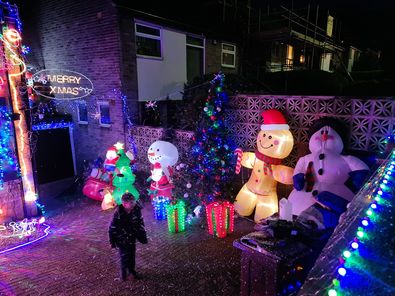 Ami shared this picture showing a front garden with huge inflatable snowmen and a gingerbread man - one of which is almost double the size of the child in the garden.